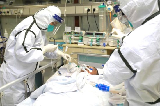 Medical staff in protective suits treat a patient with pneumonia caused by Coronavirus in Wuhan, Hubei province of China