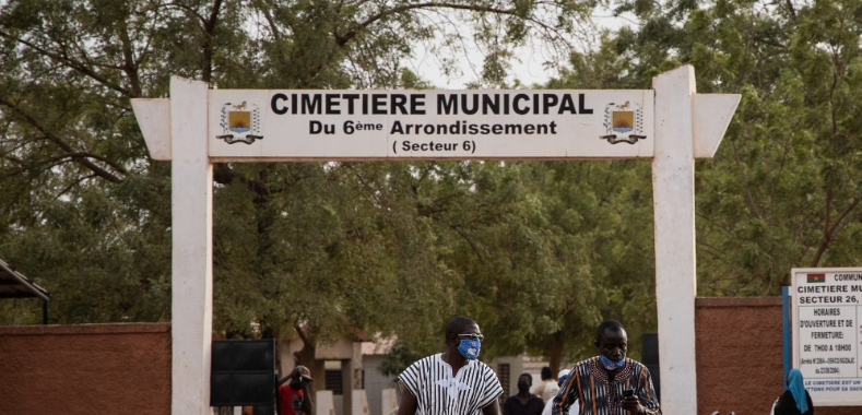 People wearing face masks are seen leaving the funeral of the first victim of the coronavirus, otherwise known as COVID-19 in sub-saharian Africa, in Ouagadougou, on Wednesday, March 18, 2020.