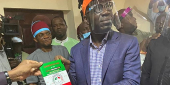 Edo State Governor Godwin Obaseki with a Peoples Democratic Party's membership card