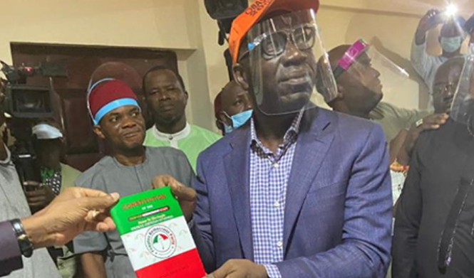 Edo State Governor Godwin Obaseki with a Peoples Democratic Party's membership card