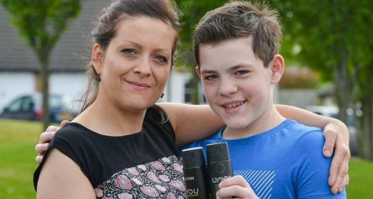 Kacper Krauze with his mother holding Lynx deodorant