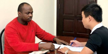 A police interrogates one of the Nigerian suspects at the police station