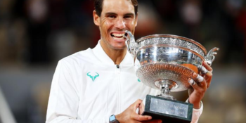 Rafael Nadal bites the winning trophy after claiming the French Open title for the 13th time time with a straight sets victory over Novak Djokovic.