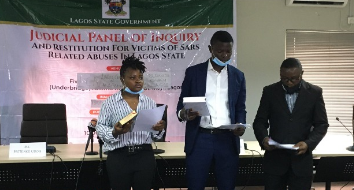 From Left to Right: Oduala and Majekodunmi being sworn in by an official as youth members of the Judicial Panel of Inquiry set up by the Lagos State Government to probe police brutality and Lekki shootings
