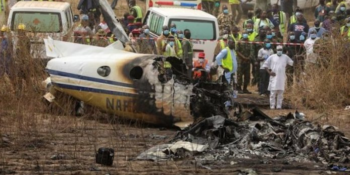Rescuers and people gather near the debris of a Nigerian air force plane, which according to the aviation minister crashed while approaching the Abuja airport runway, in Abuja, Nigeria February 21, 2021.