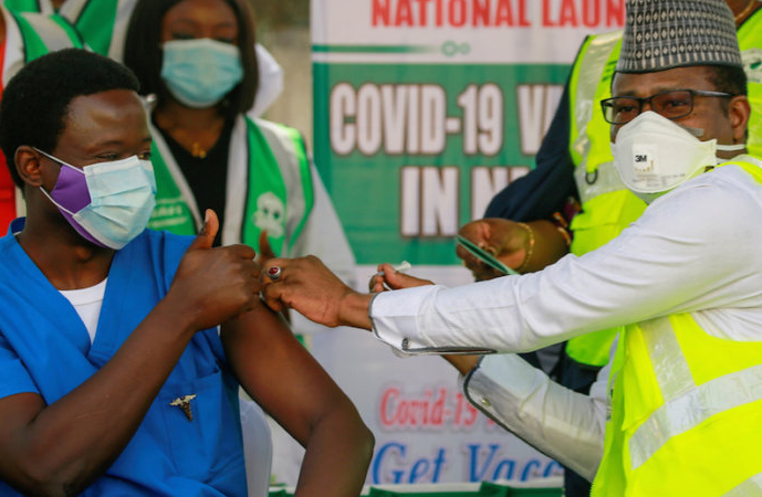 Dr Ngong Cyprian receives his first dose of the Oxford/AstraZeneca coronavirus disease (COVID-19) vaccine from Dr Faisal Shuaib, Executive Director and Chief Executive Officer of the National Primary Health Care Development Agency, at the National hospital in Abuja, Nigeria, March 5, 2021.